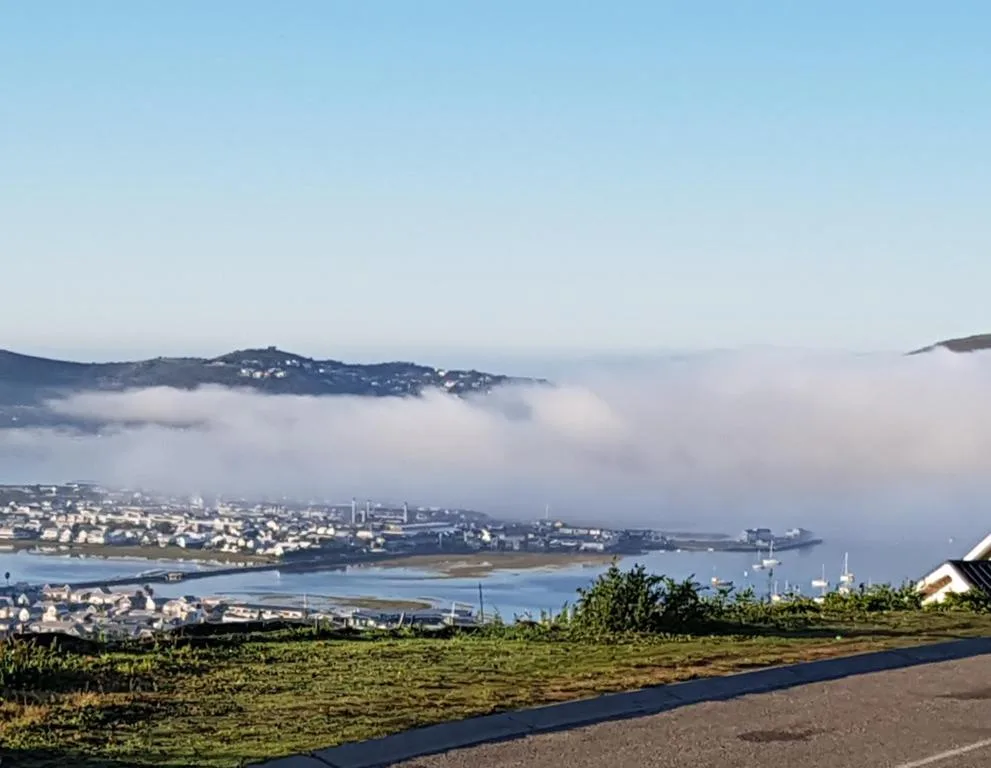 Panoramic view of Knysna Heads, lagoon, and coastal town below morning mist