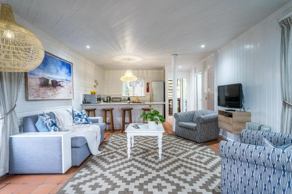 Spacious open-plan lounge with comfortable seating and television setup