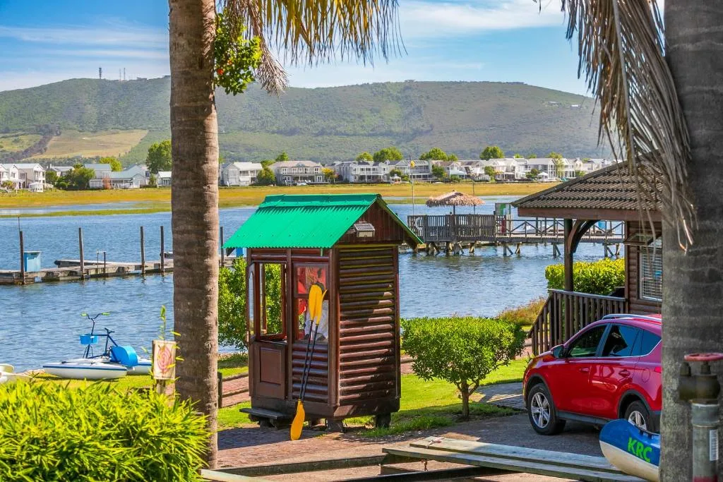 Scenic lagoon view with mountains, boats, and waterfront homes