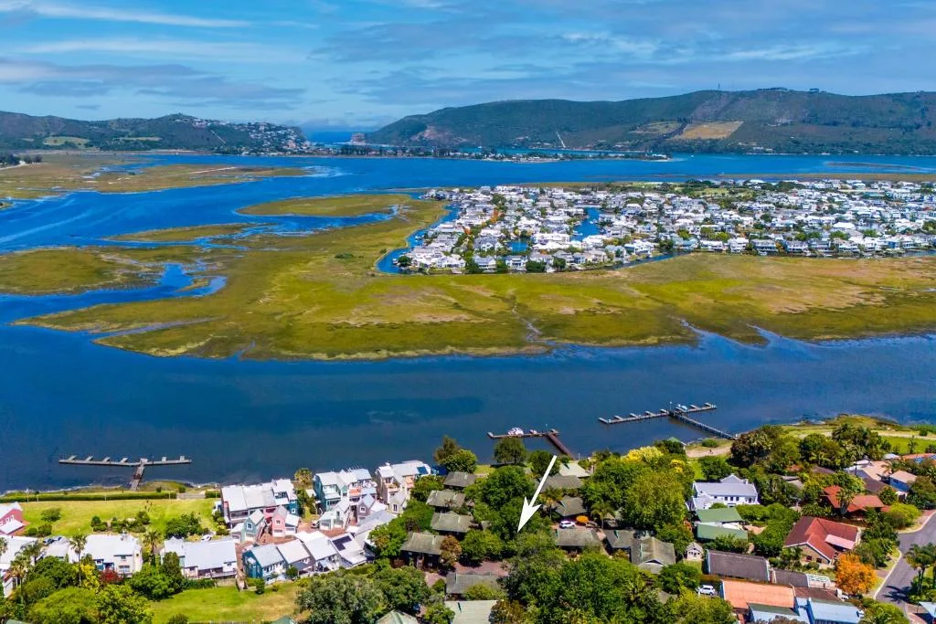 Aerial view of Knysna Lagoon with white cottage nestled among trees