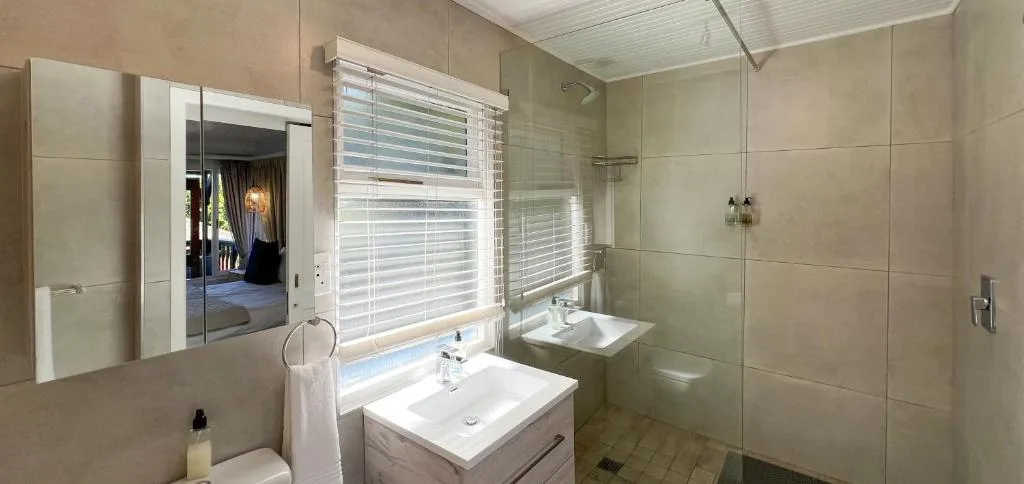 Modern bathroom with vanity, mirror cabinet, and walk-in shower enclosure
