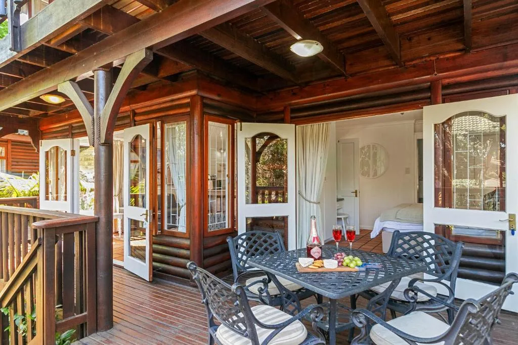 Covered wooden deck with outdoor dining table and comfortable seating area