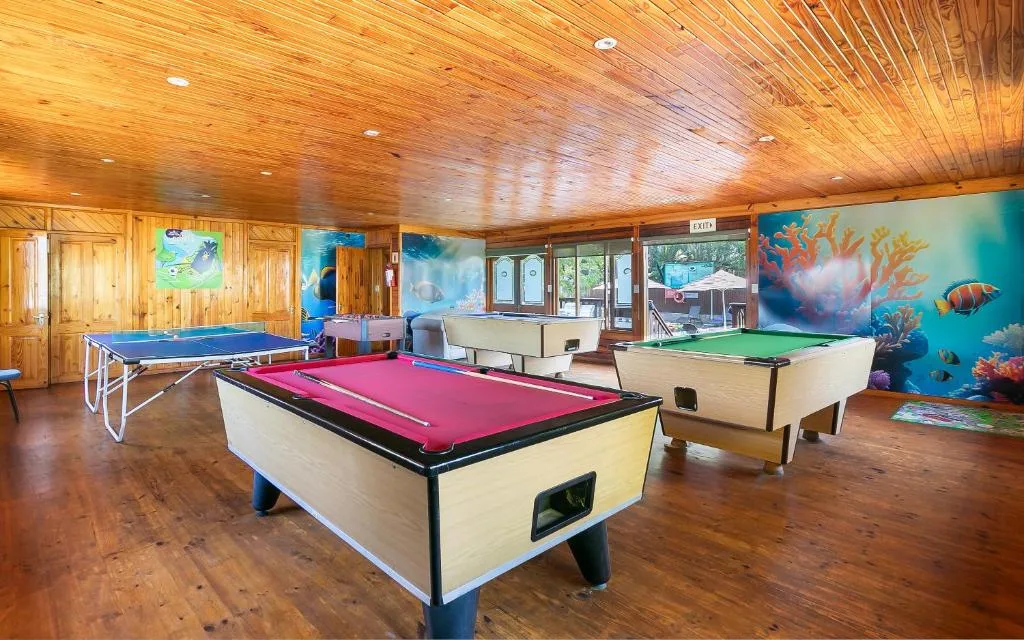 Game room with pool tables, ping pong table, and wooden ceiling