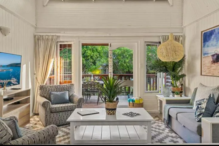 Bright lounge with comfortable seating and French doors opening to garden views