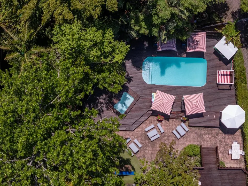 Aerial view of turquoise swimming pool on wooden deck with loungers
