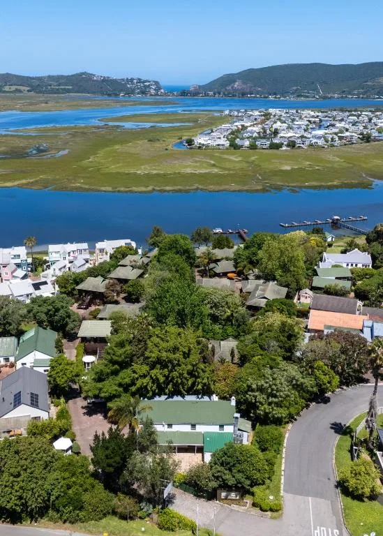 Aerial view of Knysna lagoon with white houses and blue water landscape