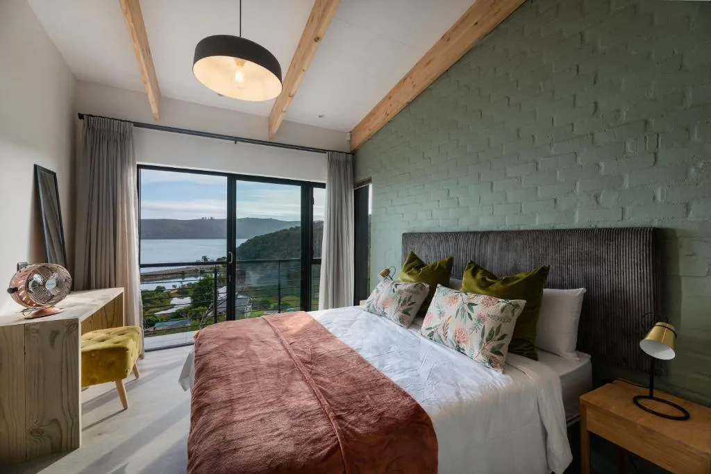 Modern bedroom with lagoon views through floor-to-ceiling sliding doors