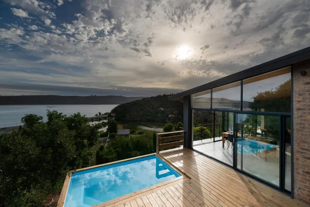 Scenic Knysna Lagoon vista from modern villa deck with pool and mountains