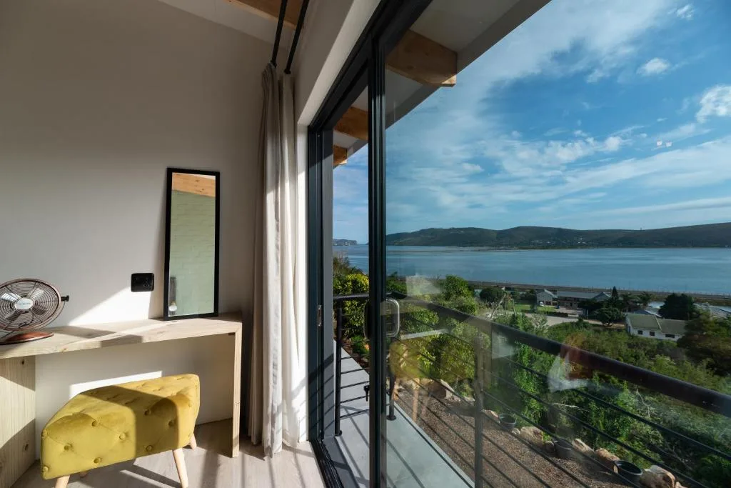 Scenic Knysna Lagoon vista from modern villa deck and interior space