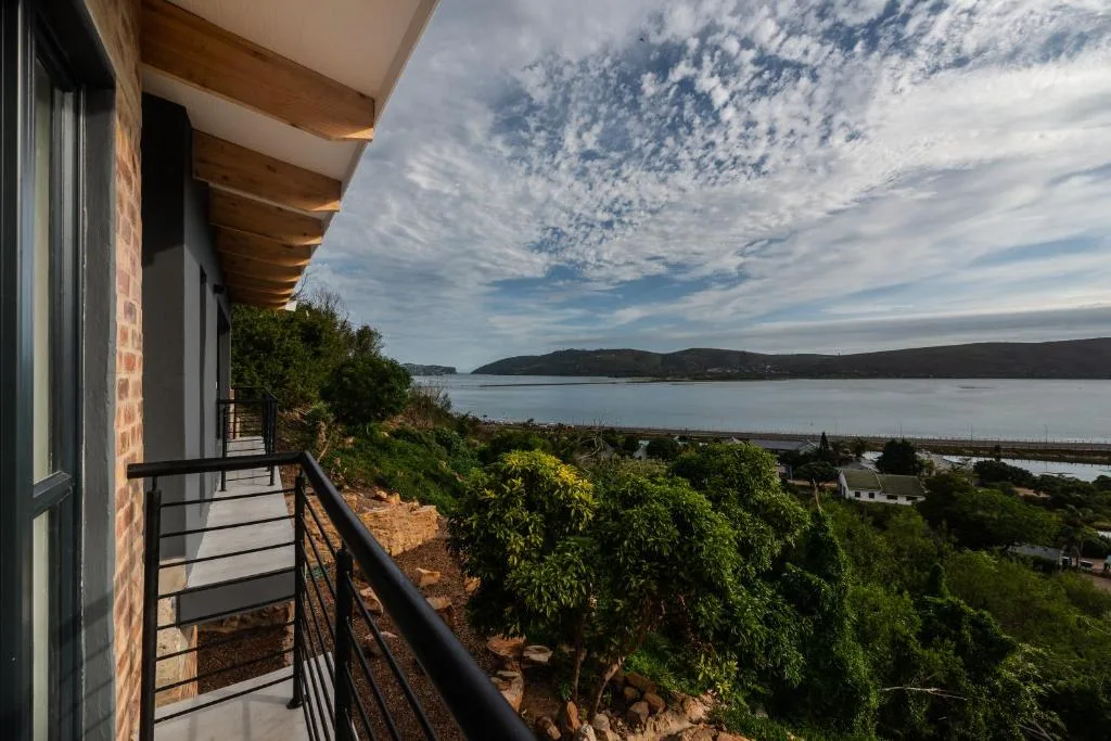 Expansive Knysna Lagoon view from modern deck with coastal vegetation