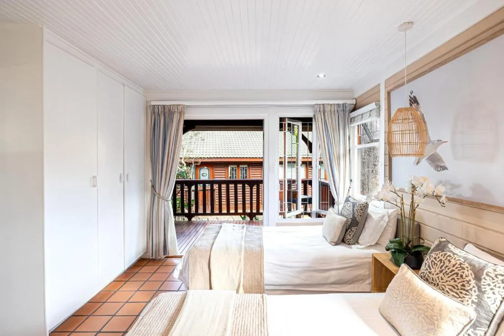 Bright bedroom with queen bed, deck access, coastal cottage decor