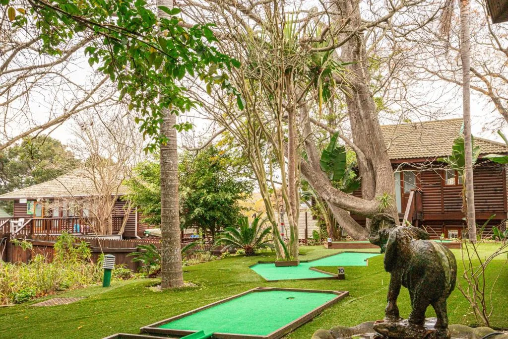Miniature golf course with elephant statue on manicured lawn