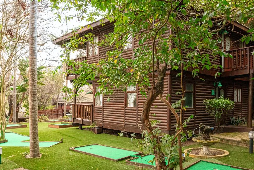 Rustic wooden chalet with manicured gardens and mini-golf course