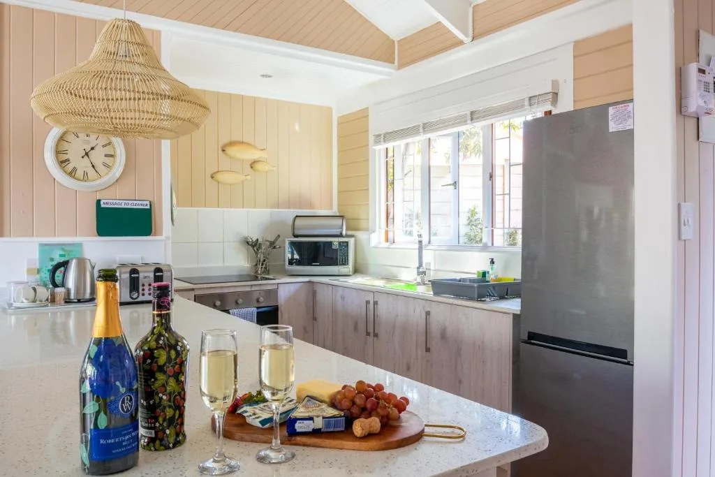 Modern kitchen with champagne, glasses, and fruit on counter