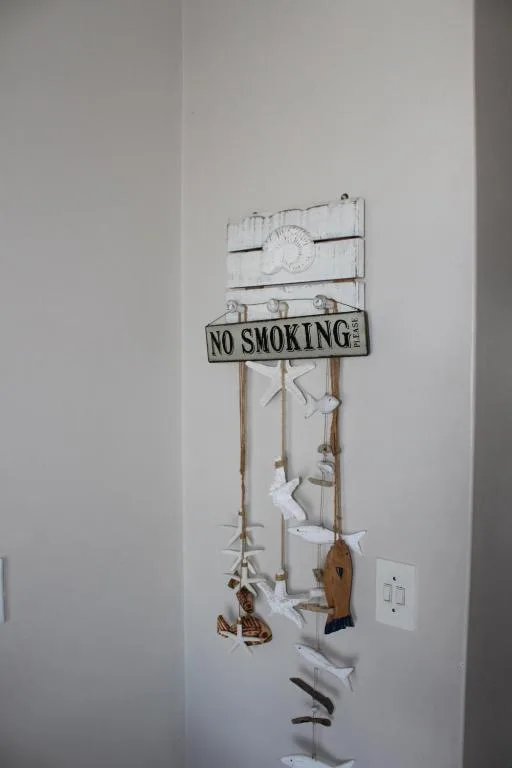 Nautical wall decoration with no smoking sign and hanging maritime ornaments
