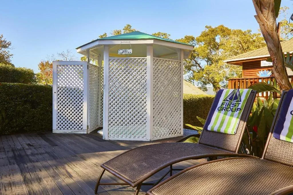 Wooden deck with outdoor seating and lattice shelter structure