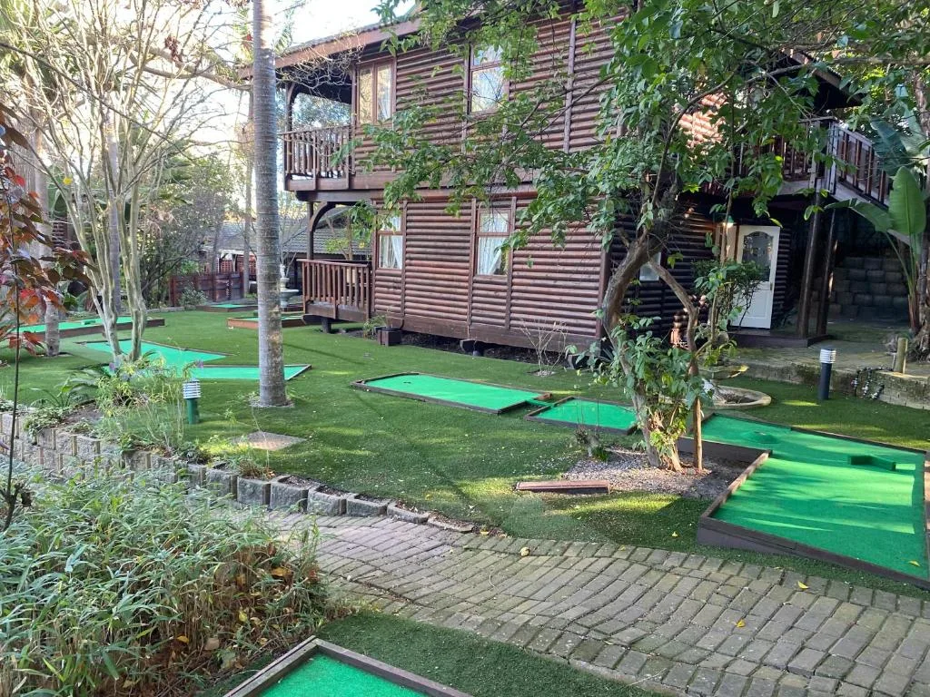 Mini golf course with green fairways and manicured lawns surrounding property