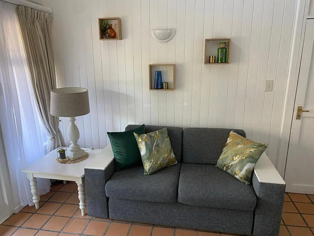 Comfortable gray sofa with decorative pillows in bright living room space