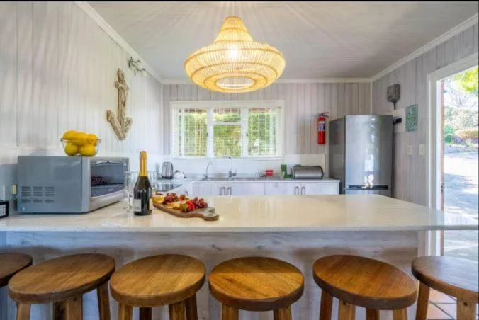Modern kitchen with island seating, stainless appliances, and pendant lighting