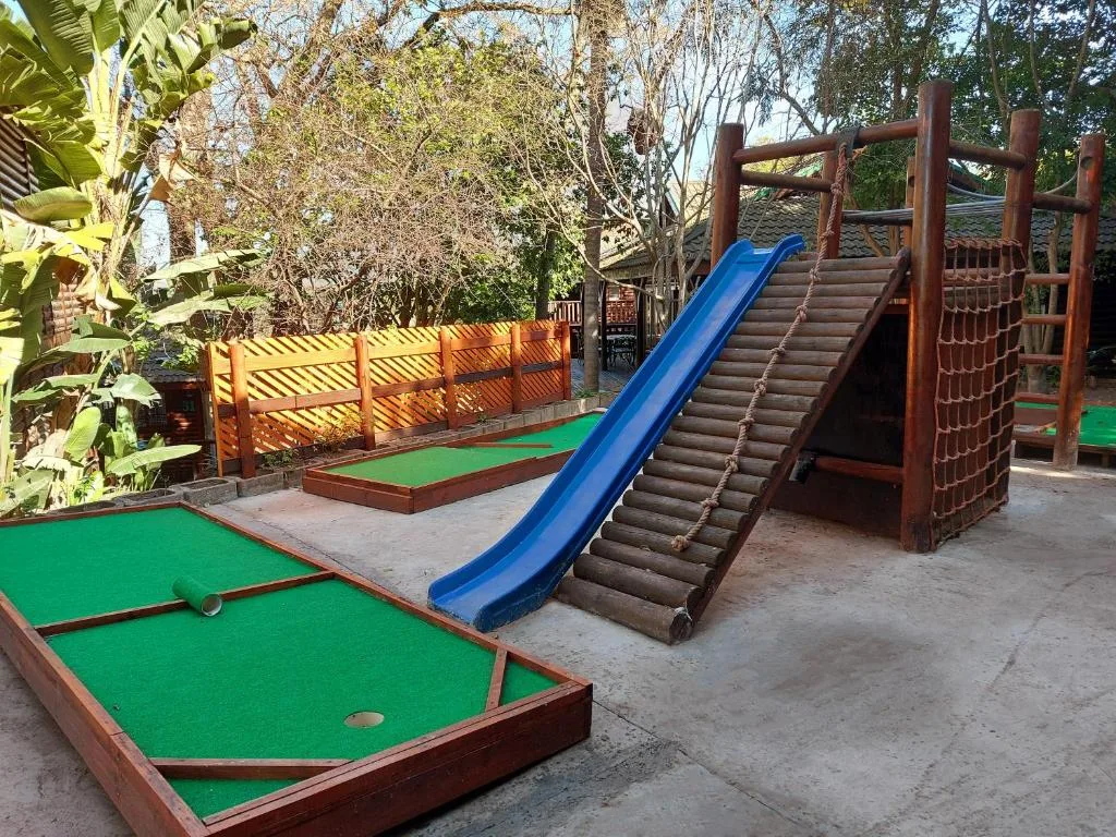 Children's play area with mini golf, slide, and climbing structure