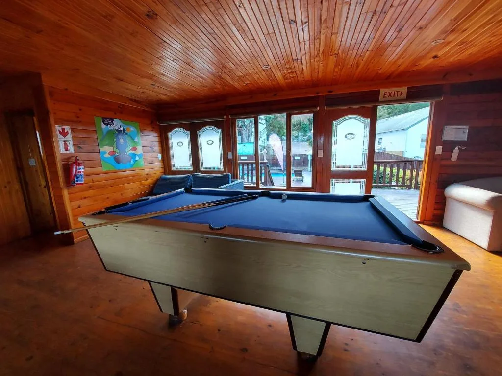 Recreation room with pool and air hockey tables, wooden interior