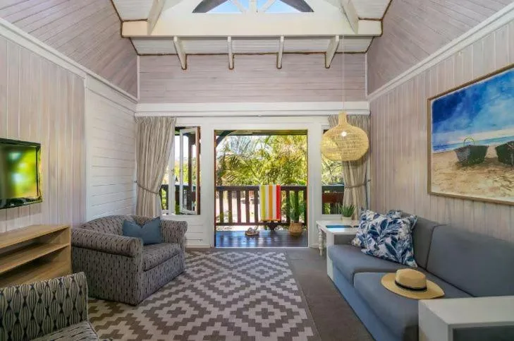 Bright lounge with comfortable seating and doors opening to deck area