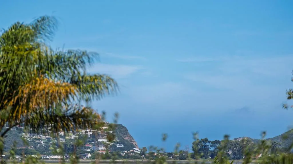 Scenic view of Knysna hillside with white buildings and blue water