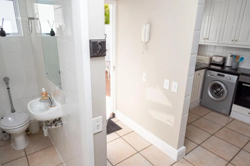 Modern bathroom with walk-in shower, vanity sink, and toilet facility