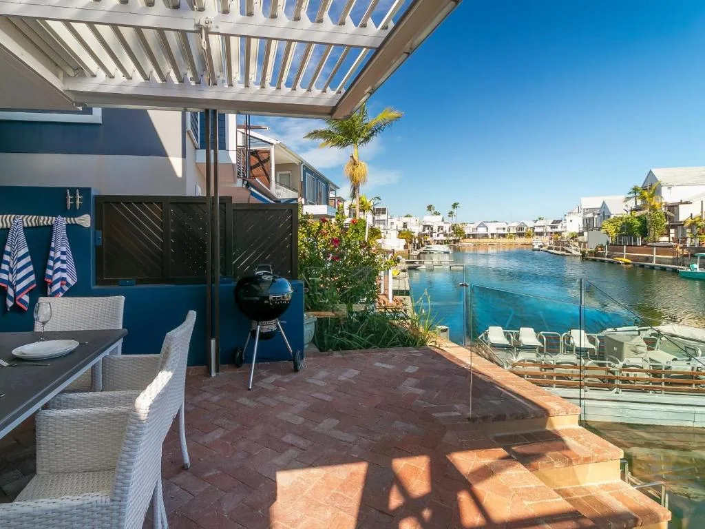 Waterfront deck with pergola, braai, and lagoon views in Knysna