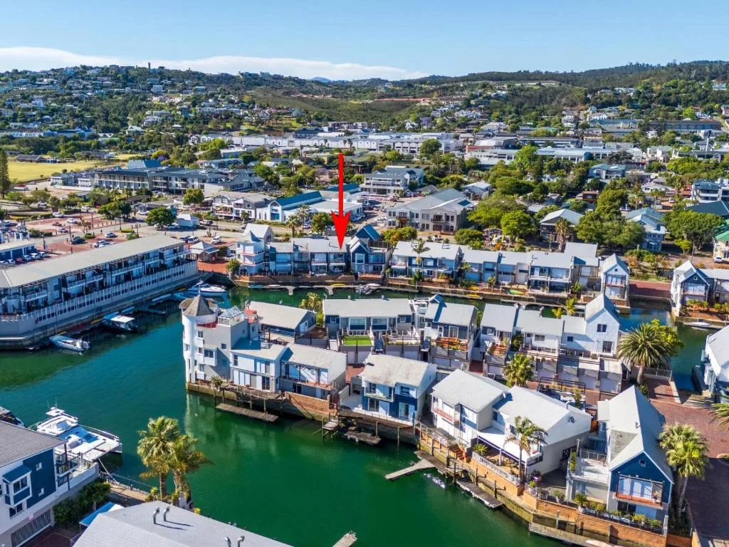 Aerial view of waterfront villa in Knysna lagoon with surrounding residential area