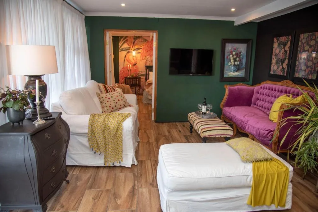 Colorful lounge with green walls, purple sofa, and comfortable seating