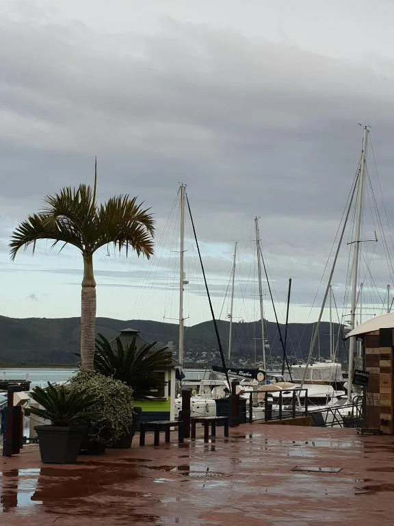 Knysna Heads lagoon with moored sailboats and mountains beyond