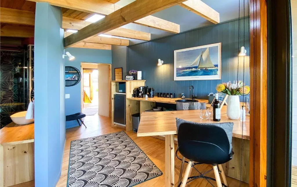 Modern kitchen with wooden counters and blue walls, open plan layout