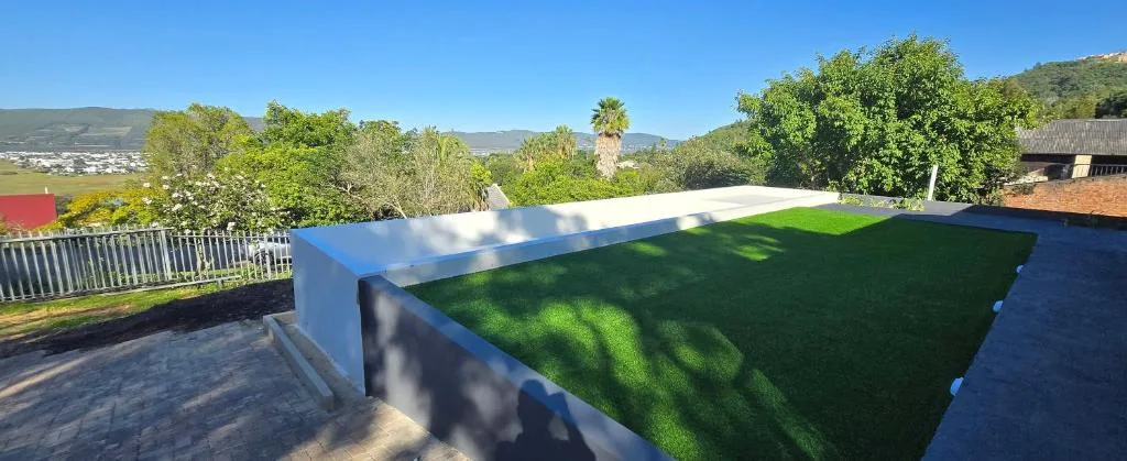 Lagoon and mountain views from property terrace with landscaped garden