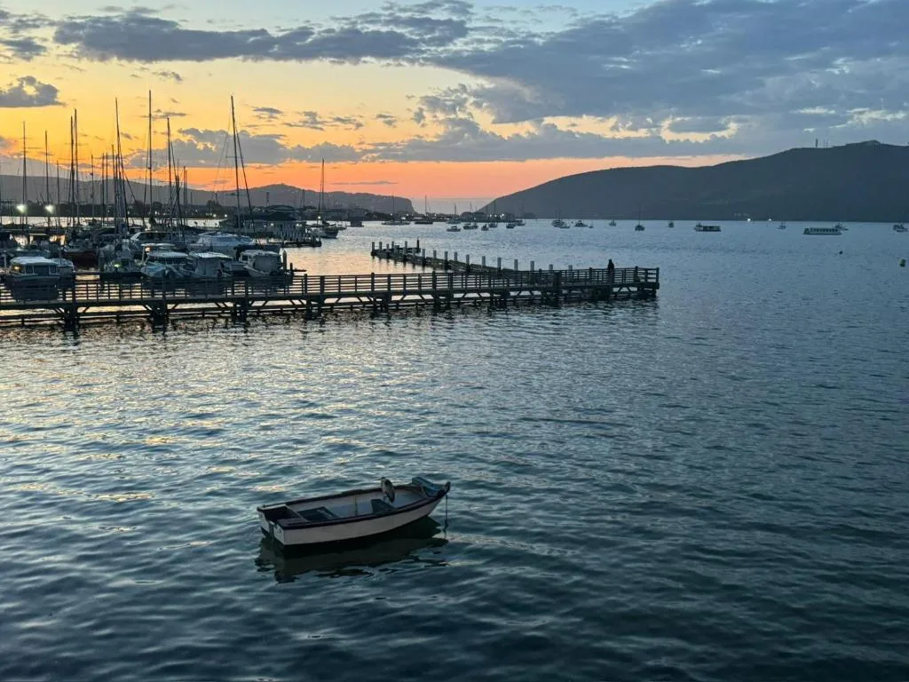 Sunset over Knysna Lagoon with moored boats and mountains
