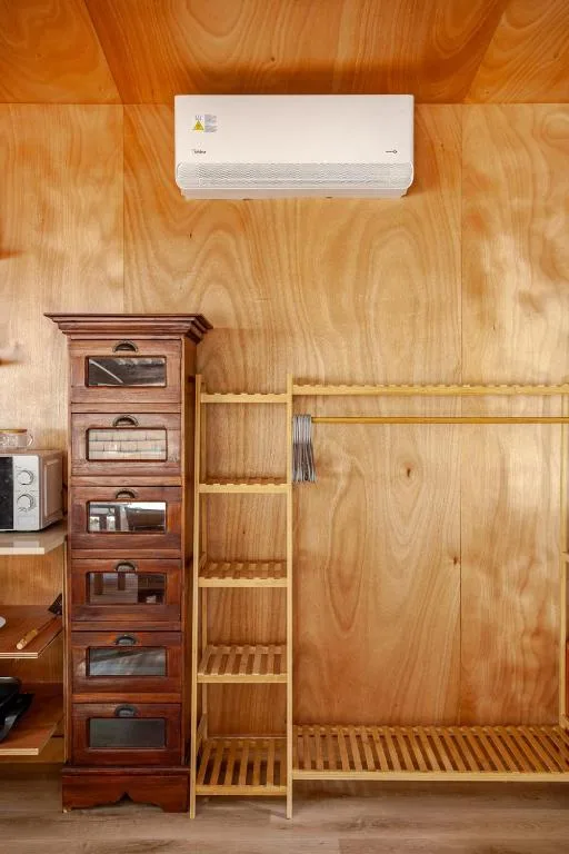Wooden interior with air conditioning unit and storage furniture.