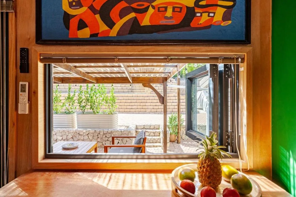 Bright living room with sliding doors opening to sunny outdoor patio area