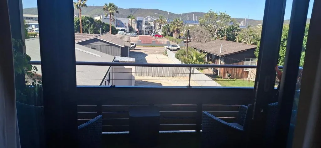 Scenic view of Knysna town, mountains, and palm trees from balcony