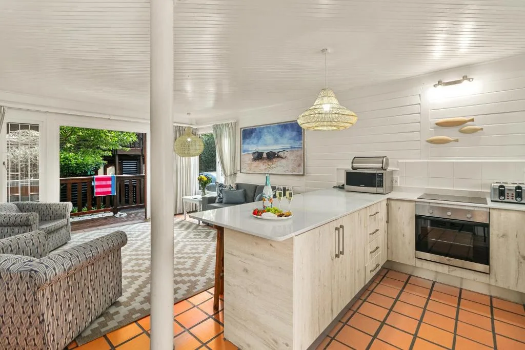 Modern open-plan kitchen with island counter and stainless steel appliances