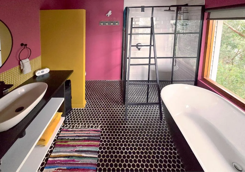 Vibrant bathroom with freestanding tub, vanity sink, and walk-in shower