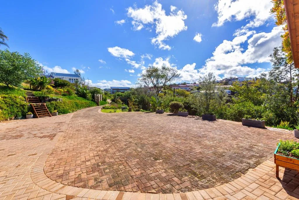 Spacious brick patio with garden views and distant lagoon vista