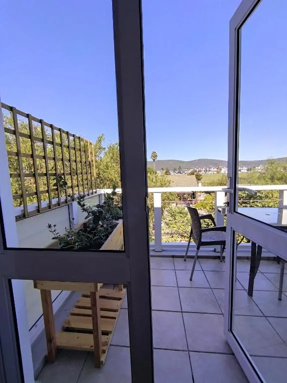 Modern deck with mountain views, potted plants, and outdoor seating