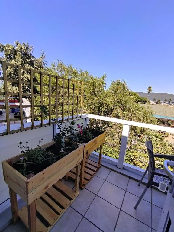 Balcony with wooden planter box and countryside views beyond