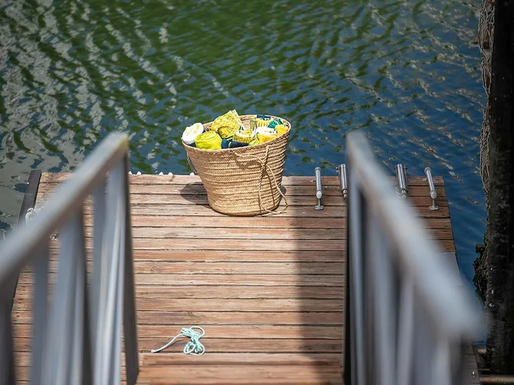 Wooden dock over water with woven basket and rope coils
