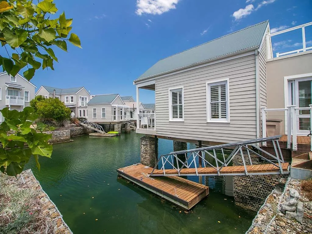 Modern waterfront holiday home with wooden deck and canal views