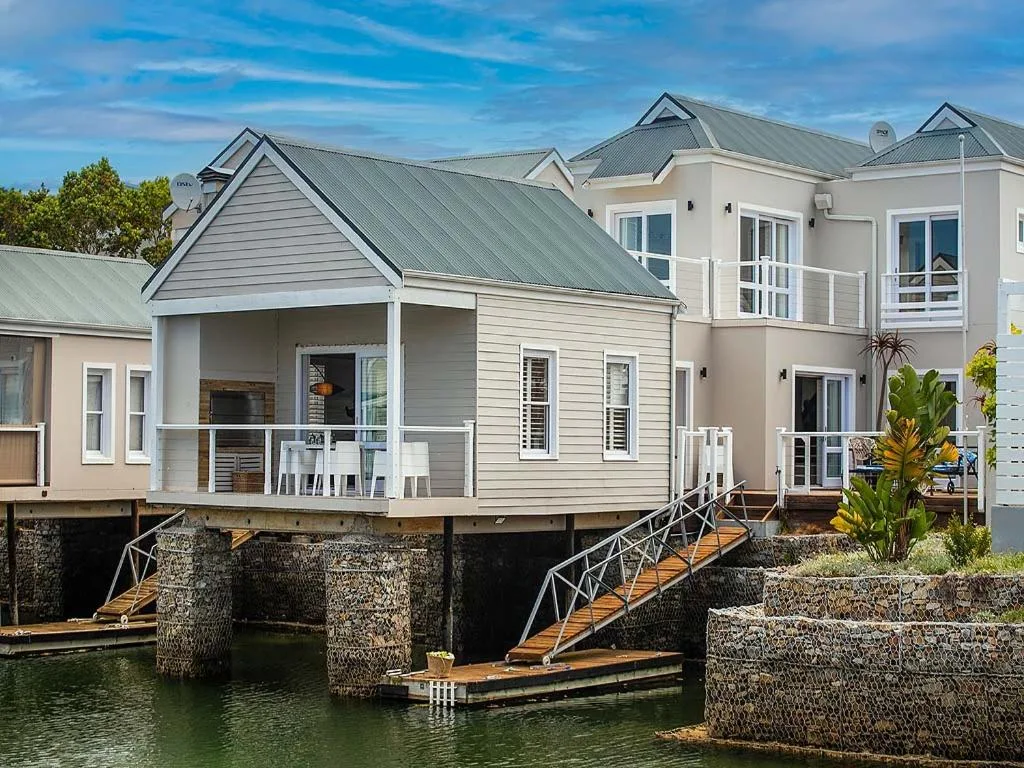 Waterfront holiday homes with modern architecture and wooden boat access