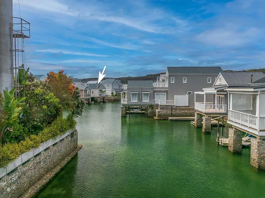 Waterfront properties with lagoon views and blue sky above
