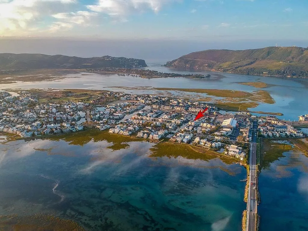 Aerial view of Knysna lagoon with mountains and coastal town development