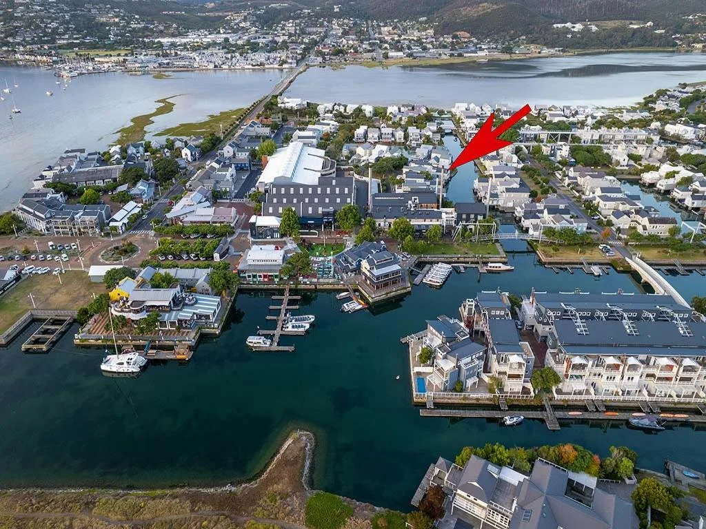 Aerial view of Knysna waterfront with lagoon, boats, and surrounding town