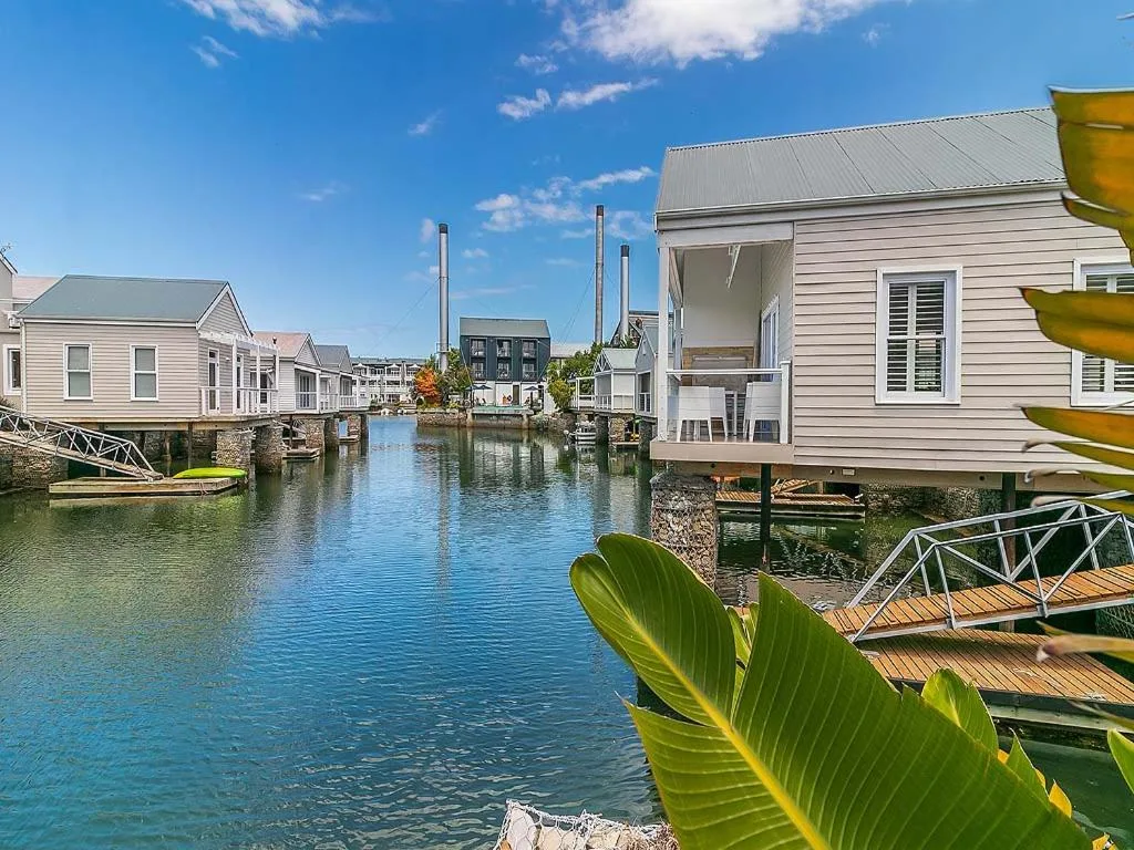 Waterfront canal homes with blue water and wooden decks
